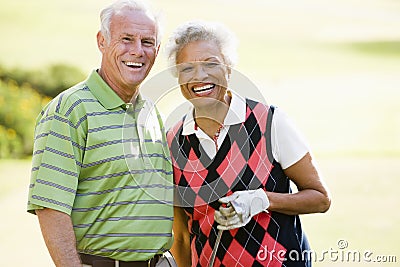 Couple Enjoying A Game Of Golf Stock Photo