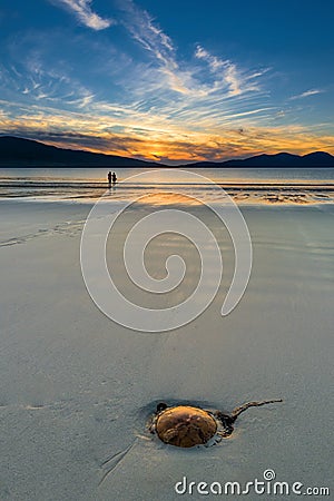 Couple enjoying gorgeous sunset on the beach. Luskentyre, Isle of Harris, Scotland. Stock Photo