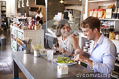 Couple Enjoying Lunch Date In Delicatessen Restaurant Stock Photo