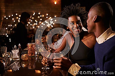 Couple Enjoying Night Out At Cocktail Bar Stock Photo