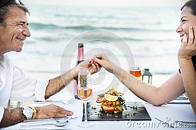Couple enjoying a private beach dinner Stock Photo