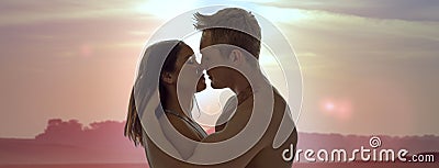 Couple enjoying a romantic sunset kiss Stock Photo