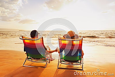Couple Enjoying Sunset at the Beach Stock Photo