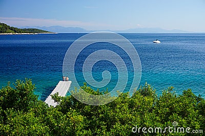 Couple enjoying view and turquoise waters in Greece Editorial Stock Photo