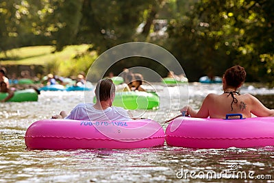 Couple Enjoys Tubing Down River In Summer Heat Editorial Stock Photo