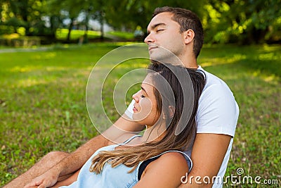 Couple fall asleep while picnic in park. Stock Photo