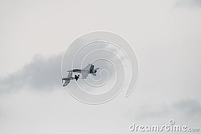 Couple of flying aircraft against a cloudy sky during an airshow Editorial Stock Photo