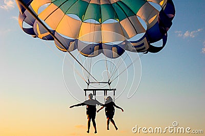 A couple flying on a parachute. Editorial Stock Photo