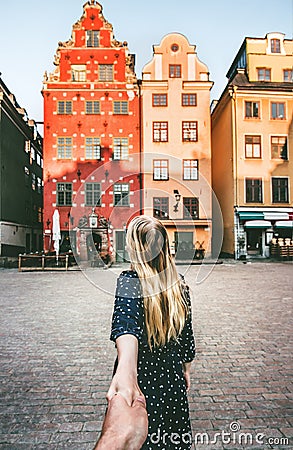 Couple follow holding hands traveling together in Stockholm Stock Photo