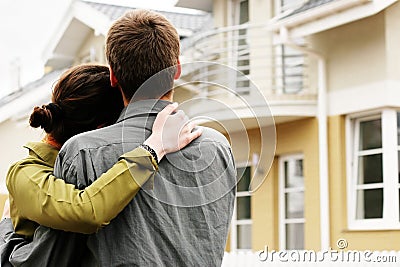 Couple in front of one-family house Stock Photo