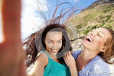 Couple of girlfriends taking fun selfies Stock Photo
