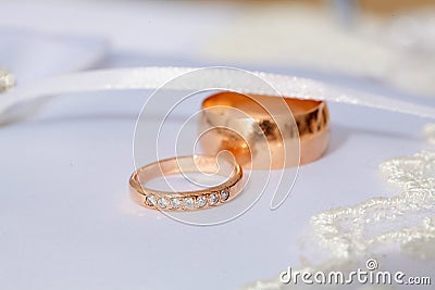 Couple of gold wedding diamond rings on wedding pillow Stock Photo