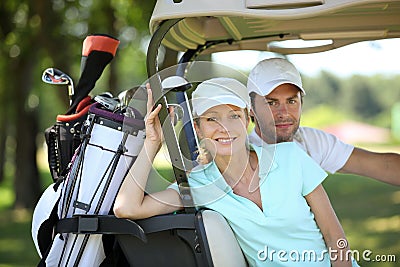 Couple in golf cart Stock Photo