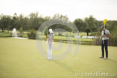 Couple at golf course Stock Photo