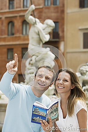 Couple With Guidebook Looking At Monuments Stock Photo