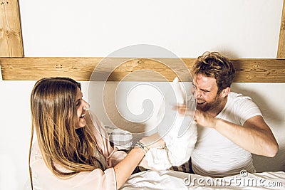 Couple of guy and girl in bed smiling and happy. Girl and guy couple showing affection in bed Stock Photo