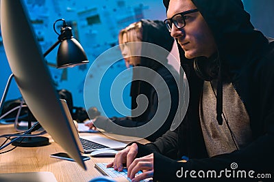 couple of hackers working with computers to develop Stock Photo