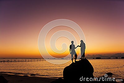 Couple hand in hand watching sunrise and sunset. Stock Photo