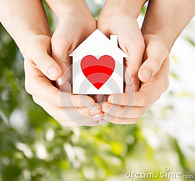 Couple hands holding white paper house Stock Photo