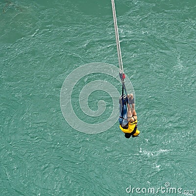 Couple hanging on a rope after a bungy jump at Kawarau Bridge Stock Photo