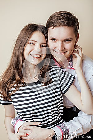 Couple of happy smiling teenagers students, warm colors having a kiss, lifestyle people concept Stock Photo