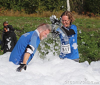 Couple having a foam fight in ExtremeRun Espoo Editorial Stock Photo
