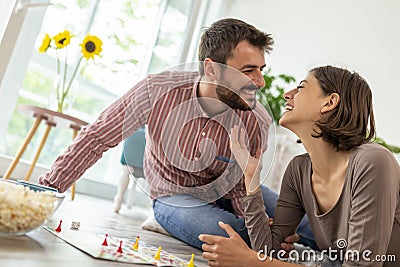 Couple having fun playing ludo board game Stock Photo