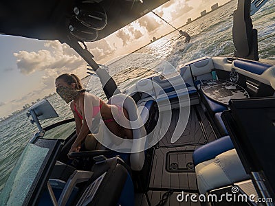 Couple having fun wakesurfing at sunset in Miami Stock Photo