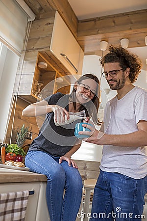Couple having milk and cereal for breakfast Stock Photo