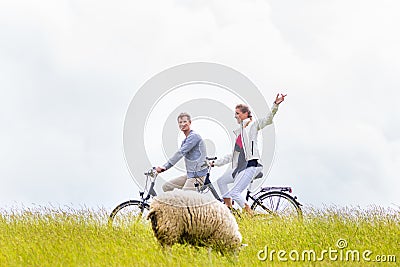 Couple having sea coast bicycle tour at levee Stock Photo