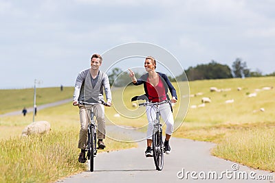 Couple having sea coast bicycle tour at levee Stock Photo