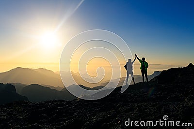 Couple hikers celebrating success concept in mountains Stock Photo