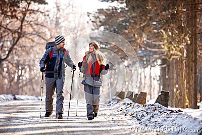 Couple of hikers walking and talking in nature Stock Photo