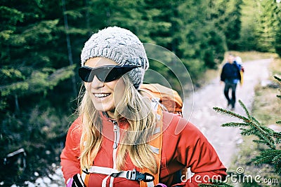 Couple hikers walking on trail in forest Stock Photo