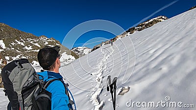 Couple hiking on snow with scenic view on Hoher Sonnblick in High Tauern mountains in Carinthia, Salzburg, Austria, Europe, Alps. Stock Photo