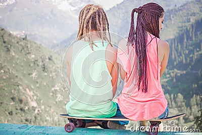 Couple of hippie, young people at mountain with longboard skateboard Stock Photo