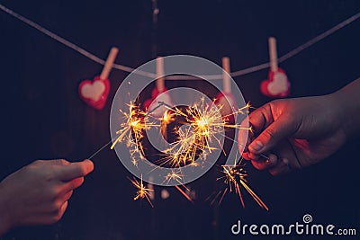 Couple holding a burning sparklers Stock Photo