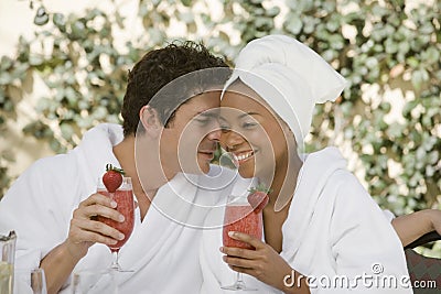 Couple Holding Glasses Of Strawberry Juice Stock Photo