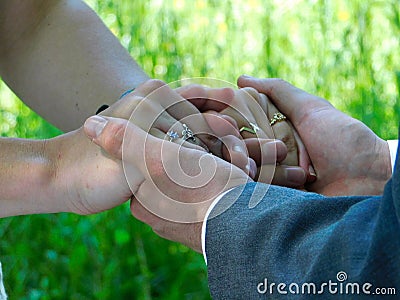 A couple holding hands during an outdoor wedding Stock Photo