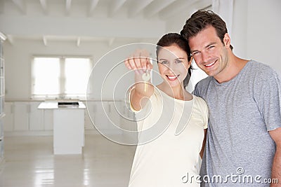 Couple holding keys in new home Stock Photo