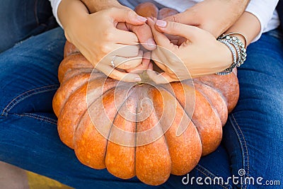 Couple holding a pumpkin Stock Photo