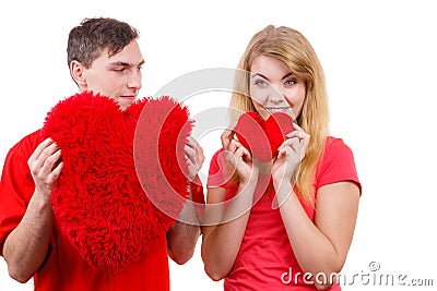 Couple holds red heart shaped pillows love symbol Stock Photo