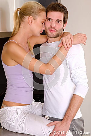 Couple at home embracing Stock Photo