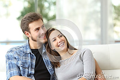 Couple at home thinking and looking sideways Stock Photo
