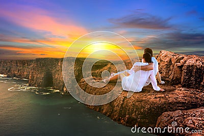 Couple in hug watching sunset Stock Photo