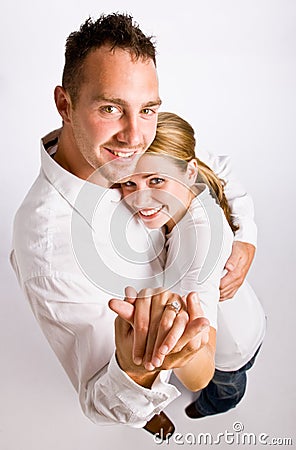 Couple hugging and displaying engagement ring Stock Photo