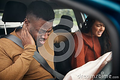 Couple Involved In Car Crash With Male Driver Suffering With Whiplash Injury Stock Photo