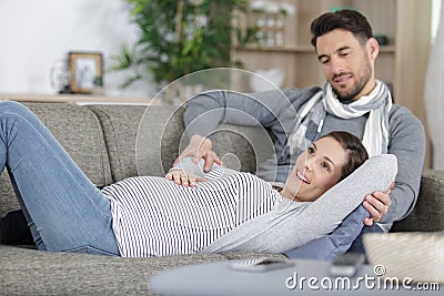 couple joyful to feel their baby move in ladys tummy Stock Photo