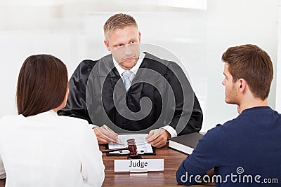 Couple with judge in court Stock Photo