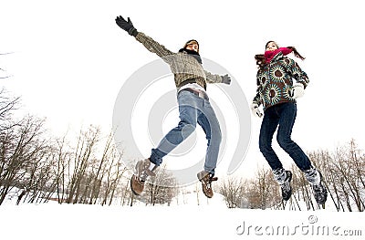 Couple jumping in snow Stock Photo